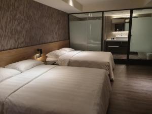 Ένα ή περισσότερα κρεβάτια σε δωμάτιο στο City Suites - Taoyuan Station