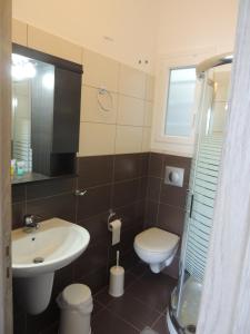 a bathroom with a sink and a toilet at levante studios Αndros in Ménites +43 photos
