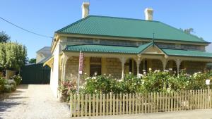a house with a fence in front of it at Cabernet Cottage in Tanunda
