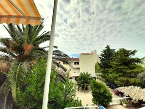 a view from a balcony of a building with palm trees at Guest House Prskalo in Makarska