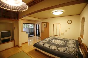 Postel nebo postele na pokoji v ubytování Masutomi Ryokan