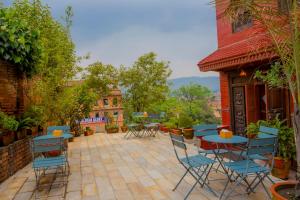 a patio with chairs and a table and a table and chairs at Welcome Heritage Inn in Bhaktapur