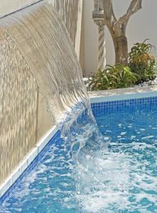a water fountain in a swimming pool at Villa Mon Repos in Colera