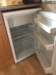 an empty refrigerator with its door open in a kitchen at Summer beach house in Saulkrasti