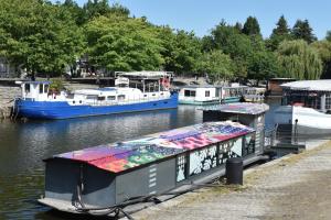 two boats are docked at a dock in the water at Surprenantes- Le DÔ in Nantes