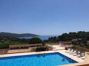 a large swimming pool with a view of the ocean at Pampelonne Appartment in La Croix-Valmer