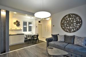a living room and kitchen with a couch and a table at Apartment A in Belgrade