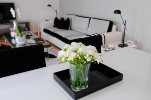 uma sala de estar com um vaso de flores sobre uma mesa em Panoramic Living em Lisboa