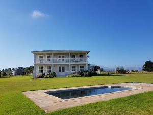 a large white house with a pool in the yard at The Noble Ant in George