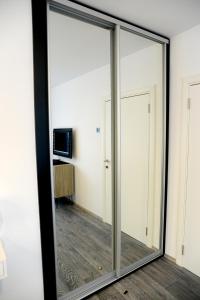 a large glass mirror in a room at Apartment A in Belgrade +8 photos