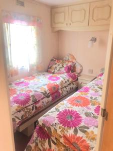 a small bedroom with two beds and a window at Summer beach house in Saulkrasti