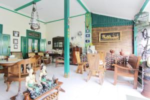 a living room with wooden furniture and a fireplace at Pendopo Andari Homestay in Yogyakarta