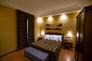 a hotel room with a bed with two pillows at Artemis Hotel in Cefalù