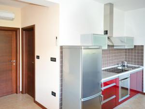 a kitchen with a refrigerator and red cabinets at Apartment Jadranka-3 by Interhome in Rab
