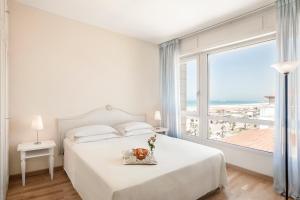 Postel nebo postele na pokoji v ubytování Hotel Sina Astor