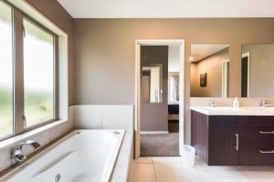 a bathroom with a tub and a sink at Rolleston Paradise-Master Bedroom with Ensuite Only in Rolleston