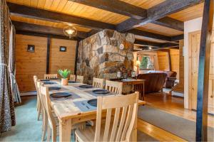 a dining room with a table and a stone wall at Creekside Chalet in Alta
