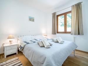 a bedroom with a bed with two pillows on it at Apartment Oltari-1 by Interhome in Biljevine