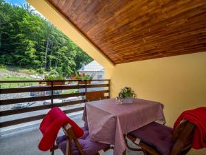 a dining room with a table and chairs on a balcony at Apartment Oltari-1 by Interhome in Biljevine
