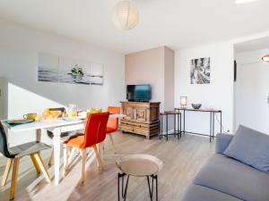 Port-HaliguenにあるApartment Les Gemeaux-3 by Interhomeのソファとテーブルと椅子のあるリビングルーム