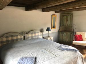 a bedroom with a large bed and a chair at Old Wing in Enköping