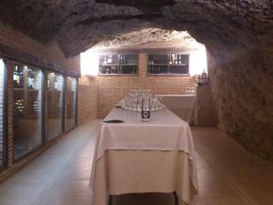 a dining room with two tables in a tunnel at Hostal Restaurante La Muralla in Oña