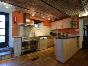 a large kitchen with a stove and a sink at Authentic Holiday Home in Gouvy near Forest in Montleban