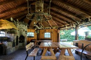 a dining room with a wooden table and a chandelier at Pokoje Gościnne OAZA in Sztutowo