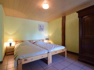 a bedroom with a bed in a room with yellow walls at Authentic Holiday Home in Gouvy near Forest in Montleban