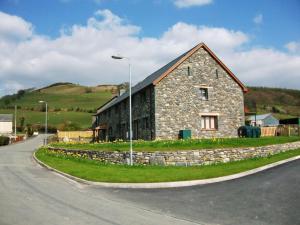 a stone building on the side of a road at Holiday Home Ty Pennal by Interhome in Pennal