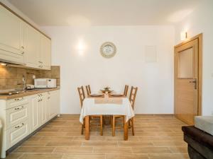 a kitchen with a table and chairs in a room at Apartment Oltari-2 by Interhome in Biljevine