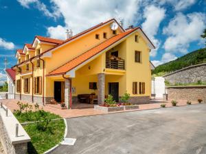 a large yellow house with a driveway at Apartment Oltari-2 by Interhome in Biljevine +33 photos