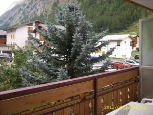 a christmas tree on the balcony of a house at Haus Apollo in Saas-Almagell