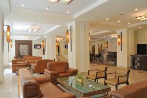 a waiting room at a hospital with chairs and a table at Ramada by Wyndham Tashkent in Tashkent