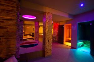 a room with a bed and a purple lighting at Zbojnicky penzion in Oravska Jasenica