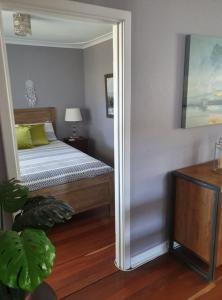 a bedroom with a bed with yellow pillows at Just Chillin in Lancelin