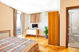 a bedroom with a bed and a bathroom at Villa Sveta Eufemija Bed end Breakfast II in Rovinj