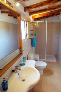 a bathroom with a sink and a toilet and a mirror at Casa Can Pep - Astbury Formentera in Sant Ferran de Ses Roques