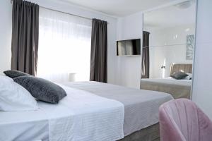 Llit o llits en una habitació de Apartment Villa Grga