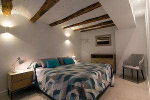 Un dormitorio con una cama y una silla en una habitación. en Casa Barrena, en Albarracín