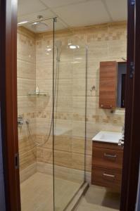 a shower with a glass door in a bathroom at Luxury Apartment near Varna, located in Targovishte in Targovishte +30 photos