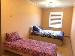 a small room with a bed and a window at MKA Life in Ventspils