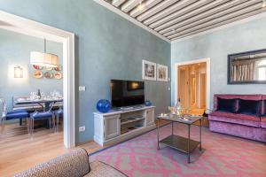 ein Wohnzimmer mit einem Sofa und einem TV in der Unterkunft La Dimora di San Maurizio 2- Dimora Italia - in Venedig