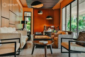 a living room with orange walls and furniture at Dreamland Oasis Hotel in Chakvi