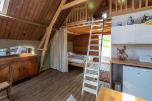 a room with a staircase in a tiny house at bnb De Loft in Kloosterzande