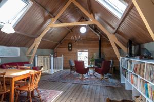 a room with a table and chairs and windows at bnb De Loft in Kloosterzande