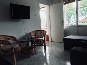 a living room with a table and chairs and a tv at Apartmani Konjević in Herceg-Novi