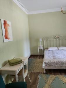 Paslepa Mõis في Paslepa: غرفة نوم مع سرير وطاولة وسرير سيد