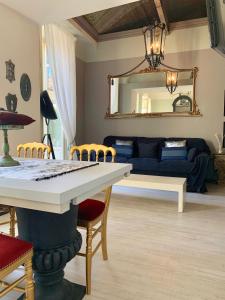 a living room with a table and a blue couch at Dimora dell'Antico Convento in Alba