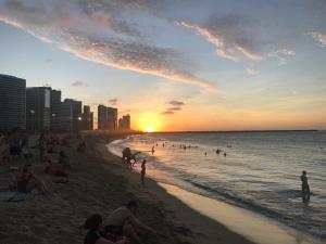 a group of people on a beach at sunset at Hotel Pousada Villa Marina in Fortaleza